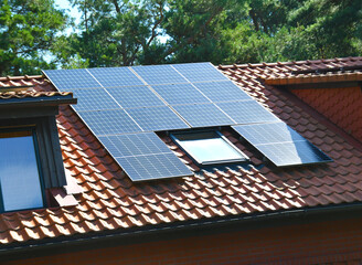 Solar Panel station on village House Roof. Solar panels on tiled roof
