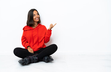 Young asian woman with roller skates on the floor intending to realizes the solution while lifting a finger up