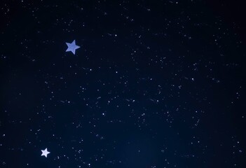 Fototapeta premium A night sky with twinkling stars and a large blue star