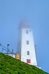 Vardø Lighthouse, in Norwegian Vardø fyr, a coastal lighthouse on the island of Hornøya, the easternmost point of Norway on a typical foggy day when sea fret rises on the island