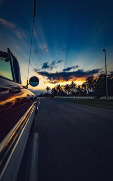 Vertical photo of moving car with beautiful sunset view