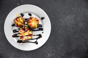 figs baked with cheese camembert or brie fresh meal food snack on the table copy space food background rustic top view keto or paleo diet vegetarian vegan food