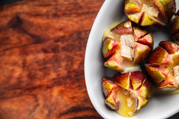 figs baked with cheese camembert or brie fresh meal food snack on the table copy space food background rustic top view keto or paleo diet vegetarian vegan food