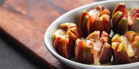 figs baked with cheese camembert or brie fresh meal food snack on the table copy space food background rustic top view keto or paleo diet vegetarian vegan food