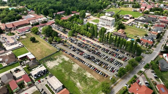 Aerial view of a busy car parking area with parallel parked vehicles