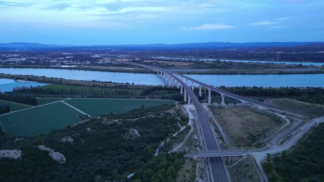 Panoramic aerial view of the double viaduct for high-speed passenger trains over the Rh&ocirc;ne river in Avignon during sunset - France