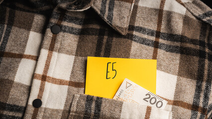 Yellow card with a handwritten inscription 