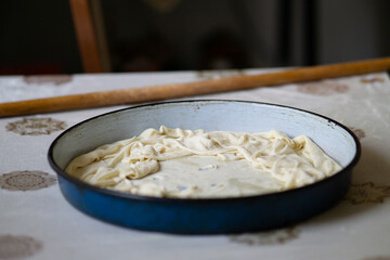 Raw rolled pie dough in a pan
