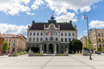 Naklejka premium Center of Ljubjiana. Buildings, architecture, castle in the capital of Slovenia. The famous bridges and the traditional symbol of the dragon. Boat on the river. City with attention to detail.