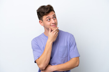 Young handsome Brazilian man isolated on white background thinking an idea while looking up