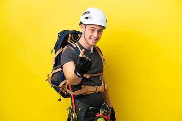 Young rock climber Brazilian man doing coming gesture