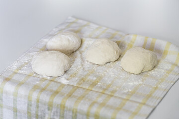 Raw dough balls on a kitchen towel