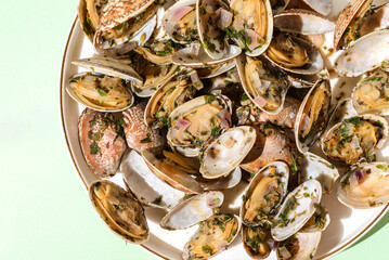 Vongole with basil and onion on a white plate