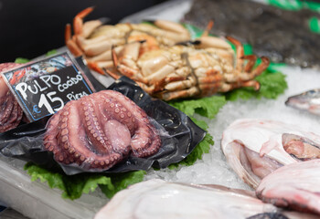 fishmonger counter with octopus in the foreground