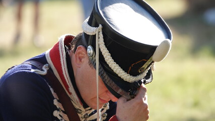 A tired hussar, a soldier of 1812, bowed his head after the battle. Chic headdress of a soldier of...