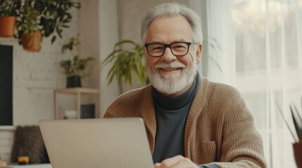 Fototapeta premium Eldery senior man working at laptop background
