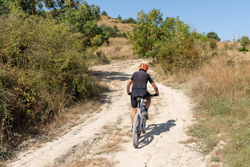 Fototapeta premium Cyclist with mountain bike on forest track