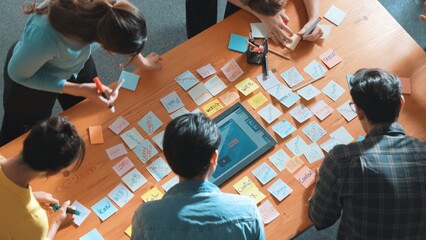 Top view of manager writing idea on sticky notes and explain idea about web design. Professional...