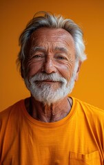 Obraz premium A man with a white beard and a smile on his face is wearing an orange shirt. The shirt has a pocket on the left side