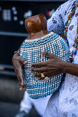 Afro Brazilian shekere beaded gourd drum close-up with colorful beads.