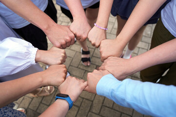 The hands of people are sealed in a circle of friendship