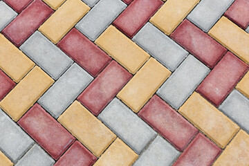 Red and yellow Brick paving stones on a sidewalk or pavement. Top view