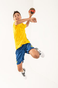 One happy handball player, teenager boy in studio isolated on white background. Hobby and healthy lifestyle