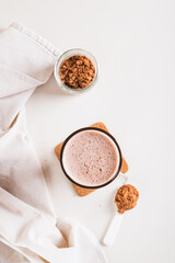 Chocolate protein energy shake drink in a glass on the table top and vertical view