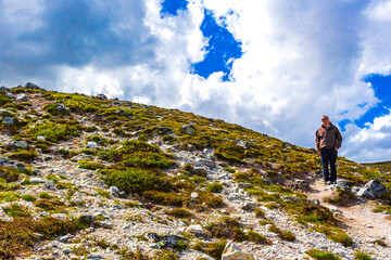 Male hiker man mountains landscape panorama Rondane National Park Norway.