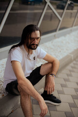 guy with long hair poses for the camera