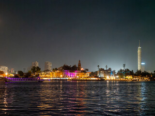 Obraz premium Night view of the city of Cairo form a boat on the Nile River , Egypt