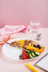 Concept individual meal plan by time food on plate on table vertical view
