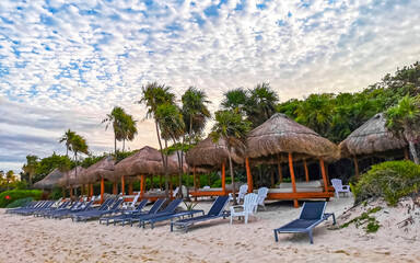 Tropical Caribbean beach people parasols fun Playa del Carmen Mexico.