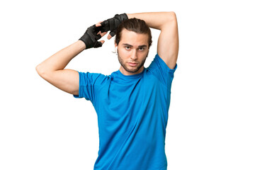 Young handsome man isolated on green chroma background stretching arm