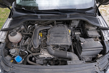 Fototapeta premium A passenger car engine mounted under the hood of the body.