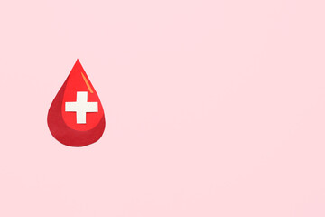 Paper blood drop with cross on pink background. World Donor Day
