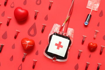 Blood pack with tubes, hearts and paper drops on red background. World Donor Day