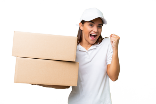 Delivery caucasian woman holding boxes isolated on green chroma background celebrating a victory in winner position