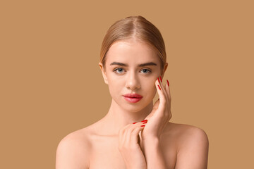 Young woman with beautiful lips on brown background