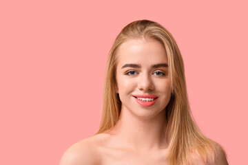 Smiling young woman with beautiful lips on pink background