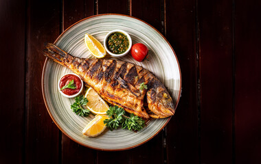 grill fish on plate top view. fried fish top view