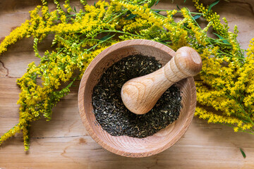 Flat lay composition with fresh yellow herbs and mortar on wooden table. - Powered by Adobe