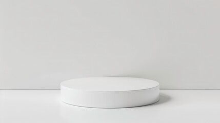 A simple white cylinder sits on a white surface against a white background.