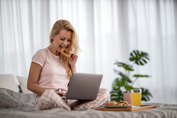 Fototapeta premium Woman Shopping Online from Bedroom