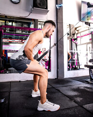 Fototapeta premium a man concentrates on his pulley exercise routine