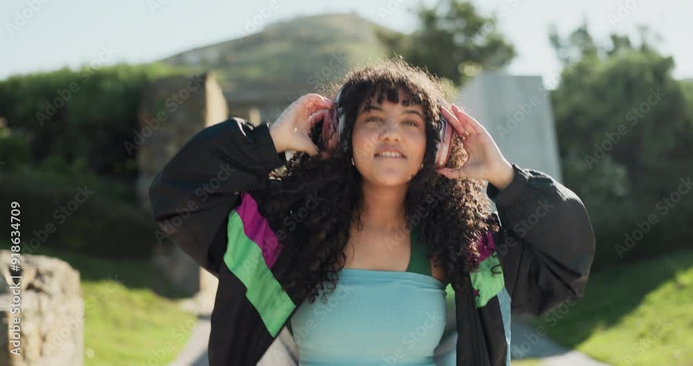 Wall mural Dance, headphones and a woman walking in a park during summer for freedom or movement in rhythm. Portrait, energy or fashion with a happy young person moving to music in a garden for stress relief