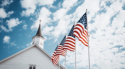 American flags and church steeple against blue sky