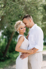 Happy Bride and Groom Embracing Outdoors on Their Wedding Day