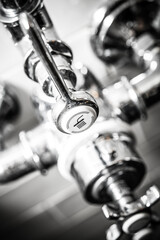 Close-up of a Modern Kitchen Faucet Lever with a Sleek Chrome Finish: Ideal for Home Renovation and Interior Design Projects