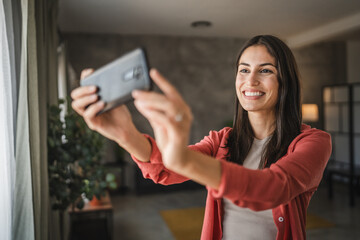 Self portrait of adult young caucasian woman stand and smile